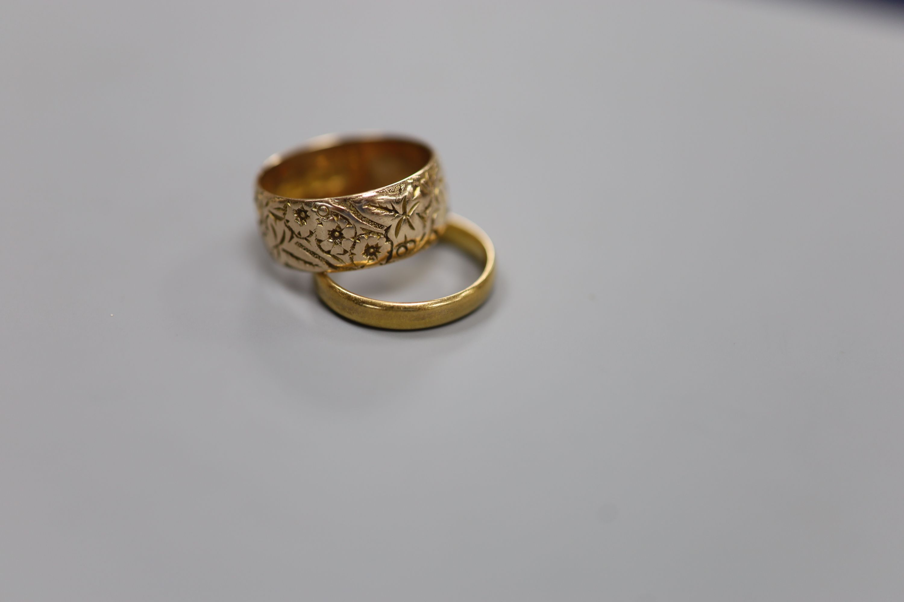 A 9ct gold wedding band, 4.5 grams and a 22ct gold wedding ring, 3.3 grams.